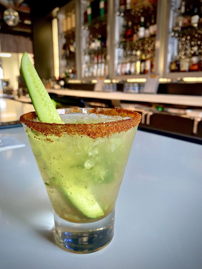 cucumber mint smash cocktail on bar