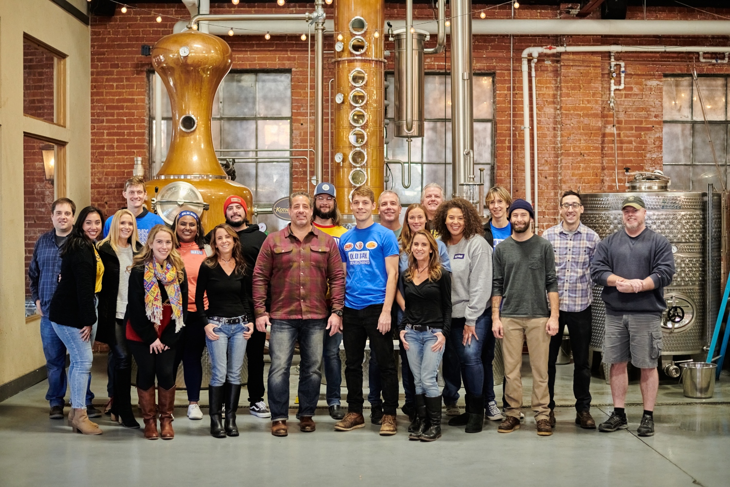 team of people standing inside distillery