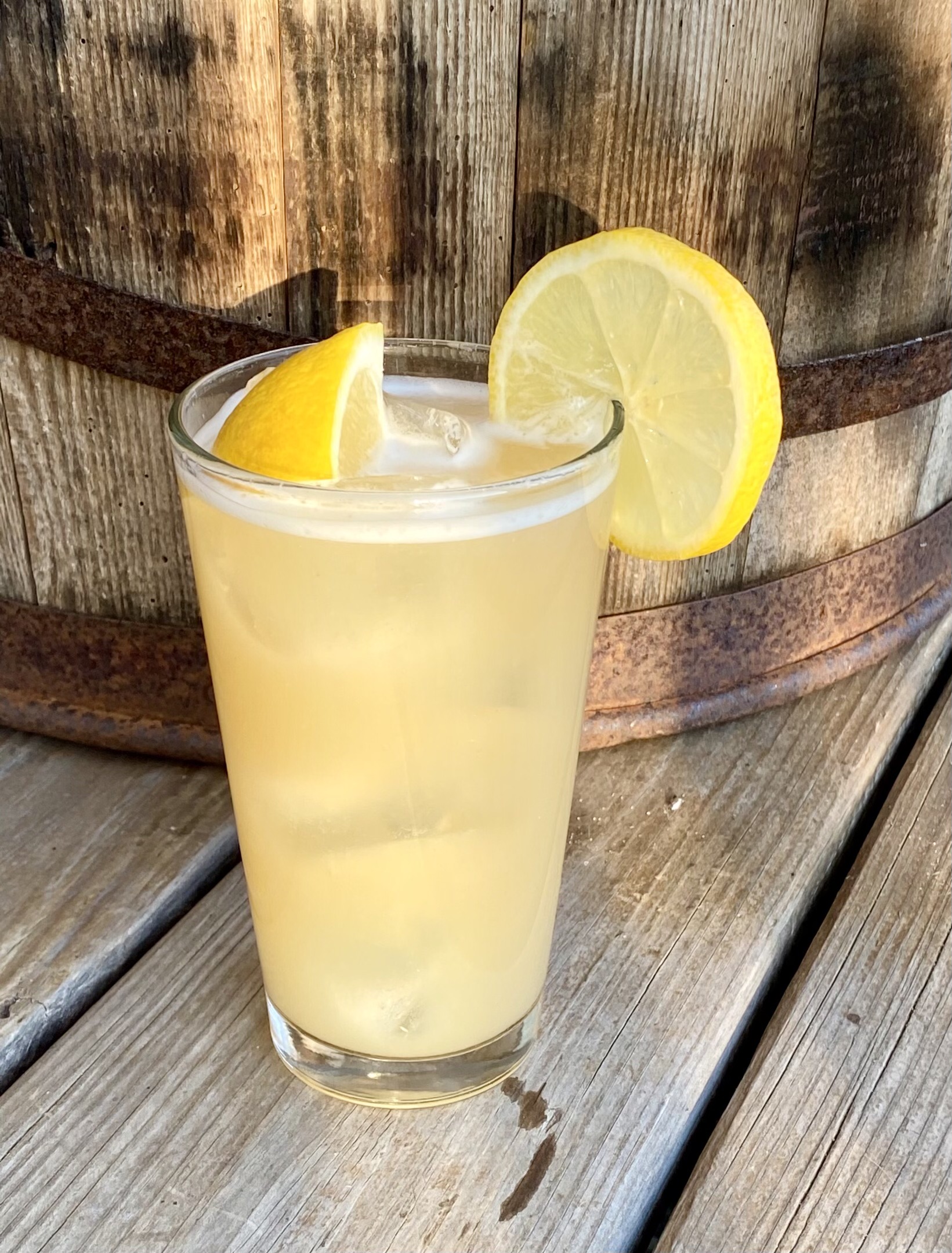 bay lemonade cocktail with lemon on deck