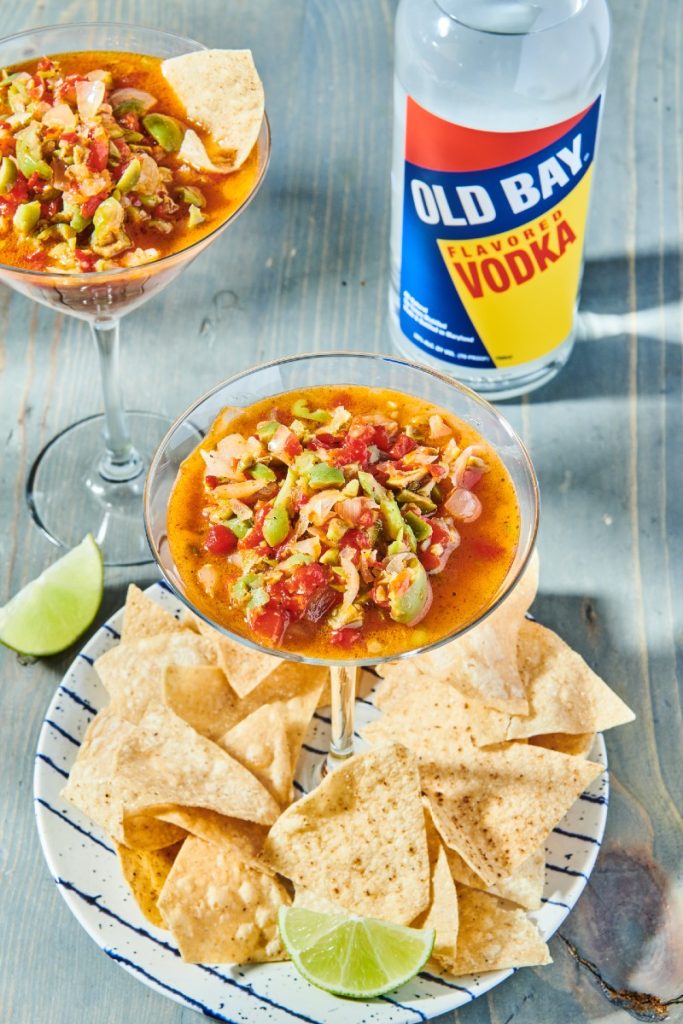 salsa with chips and old bay vodka bottle