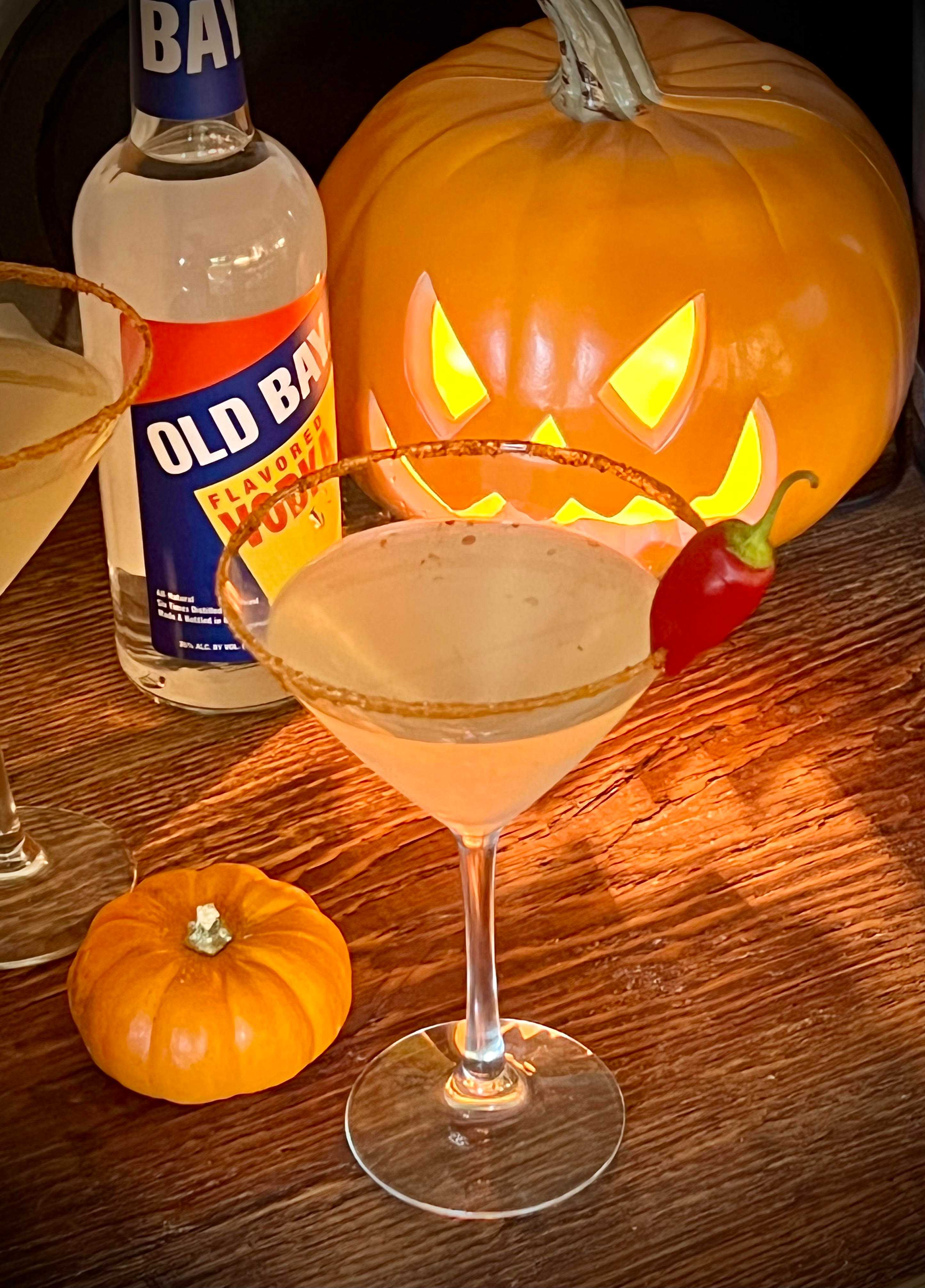 pumpkin with martini and old bay vodka bottle