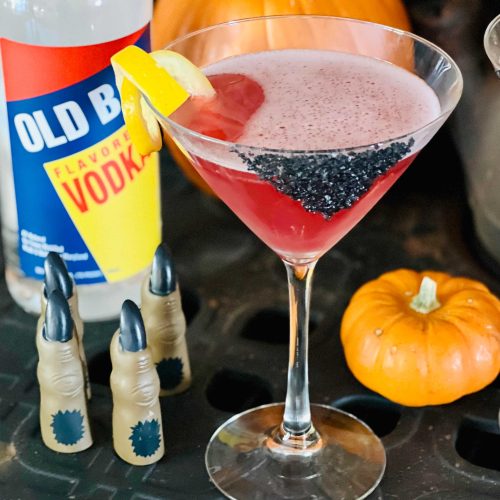 red martini with old bay vodka, pumpkin, and halloween fingers decorations