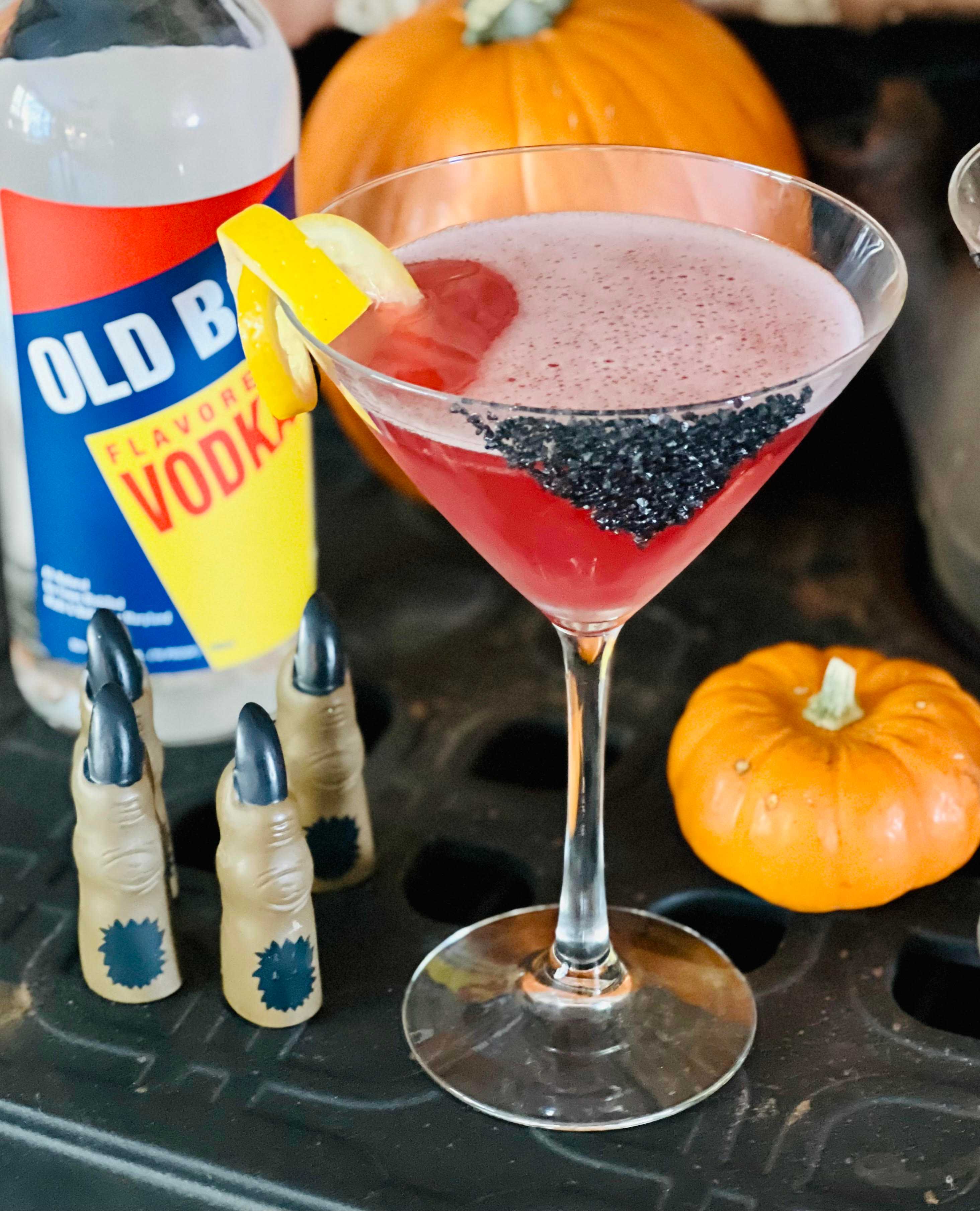 red martini with old bay vodka, pumpkin, and halloween fingers decorations