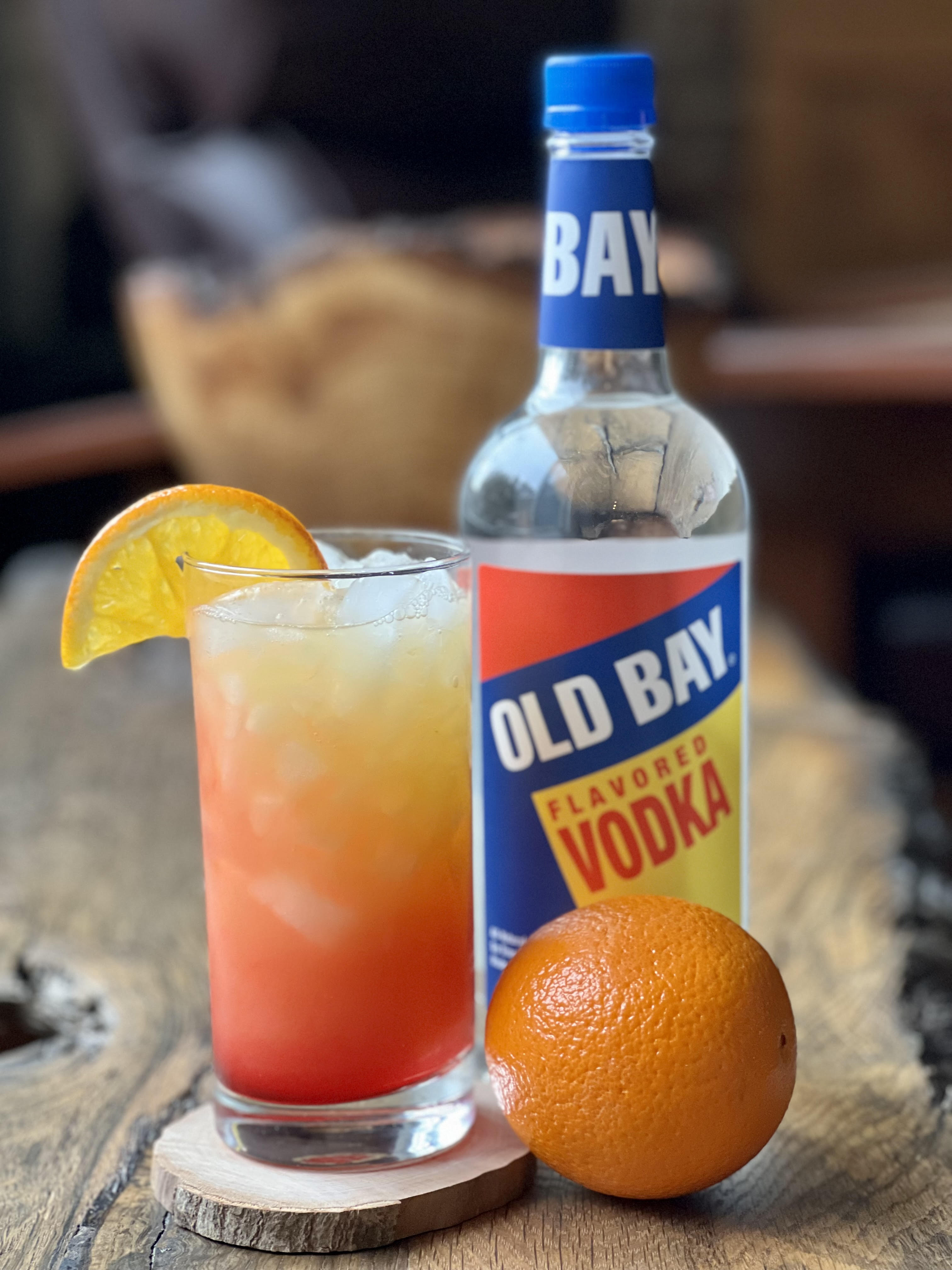 cocktail with old bay vodka bottle and orange