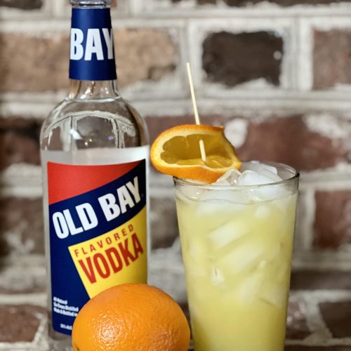 crush cocktail with old bay vodka bottle and orange