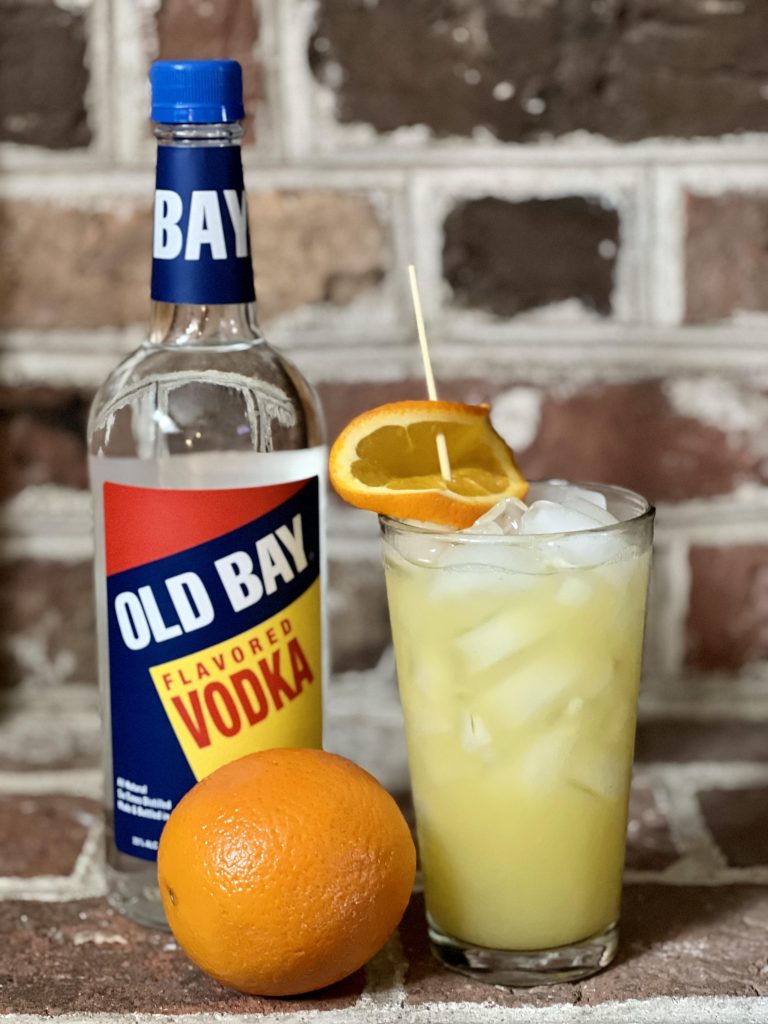 crush cocktail with old bay vodka bottle and orange
