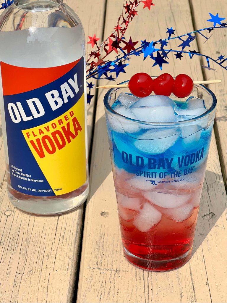 old bay vodka bottle with red white and blue cocktail with cherries