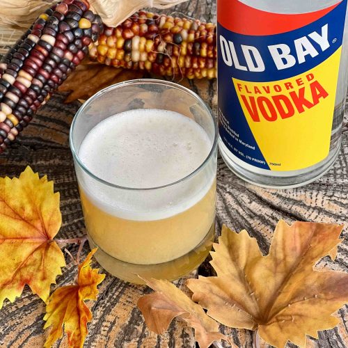 old bay vodka bottle with cocktail and fall leaves