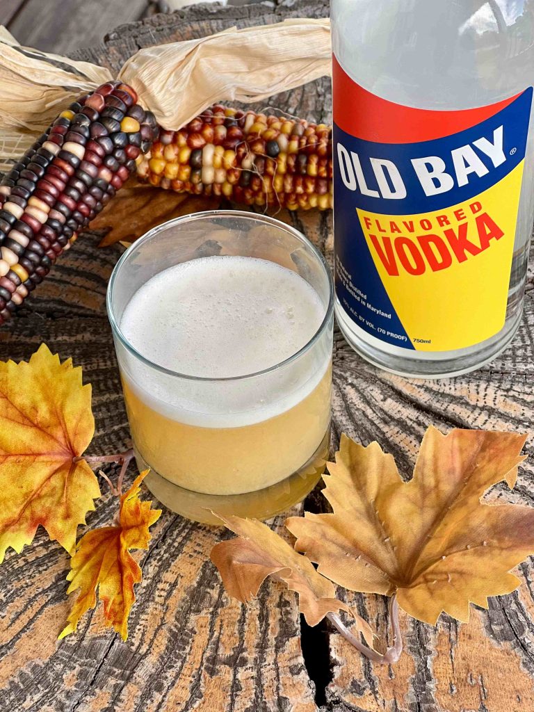 old bay vodka bottle with cocktail and fall leaves