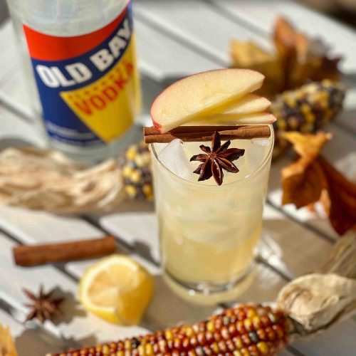 Old Bay Vodka bottle with apples on top of cocktail