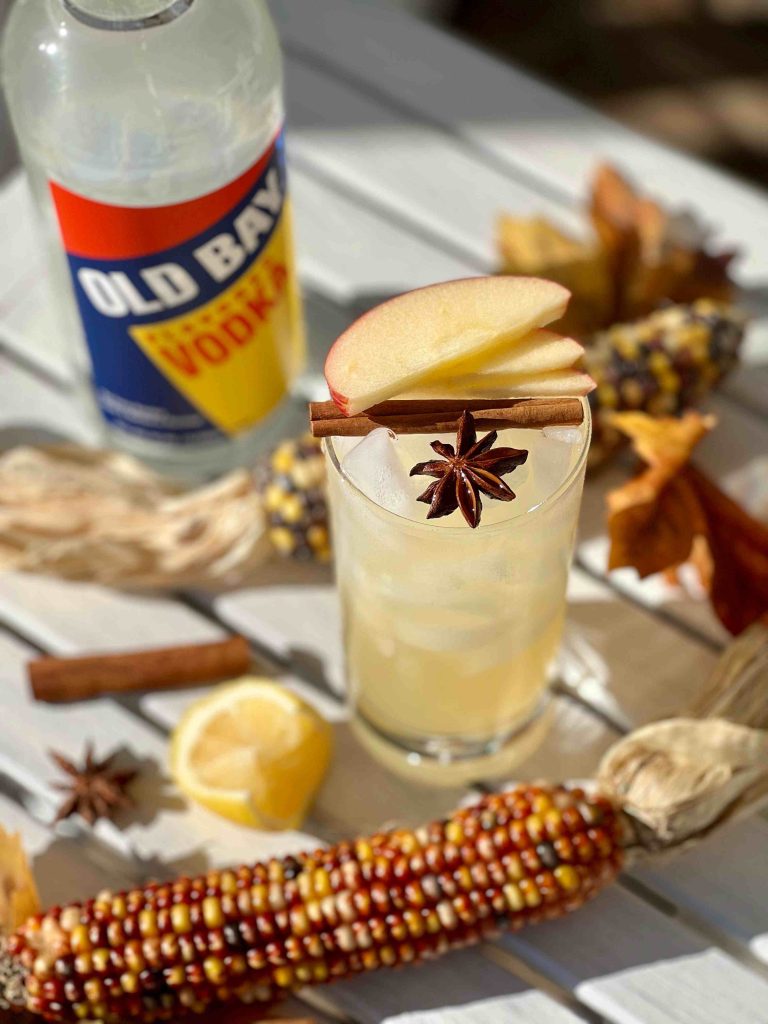 Old Bay Vodka bottle with apples on top of cocktail