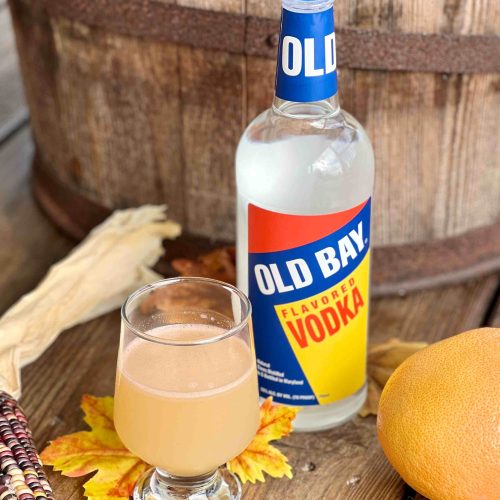 Old Bay Vodka bottle with cocktail by barrel