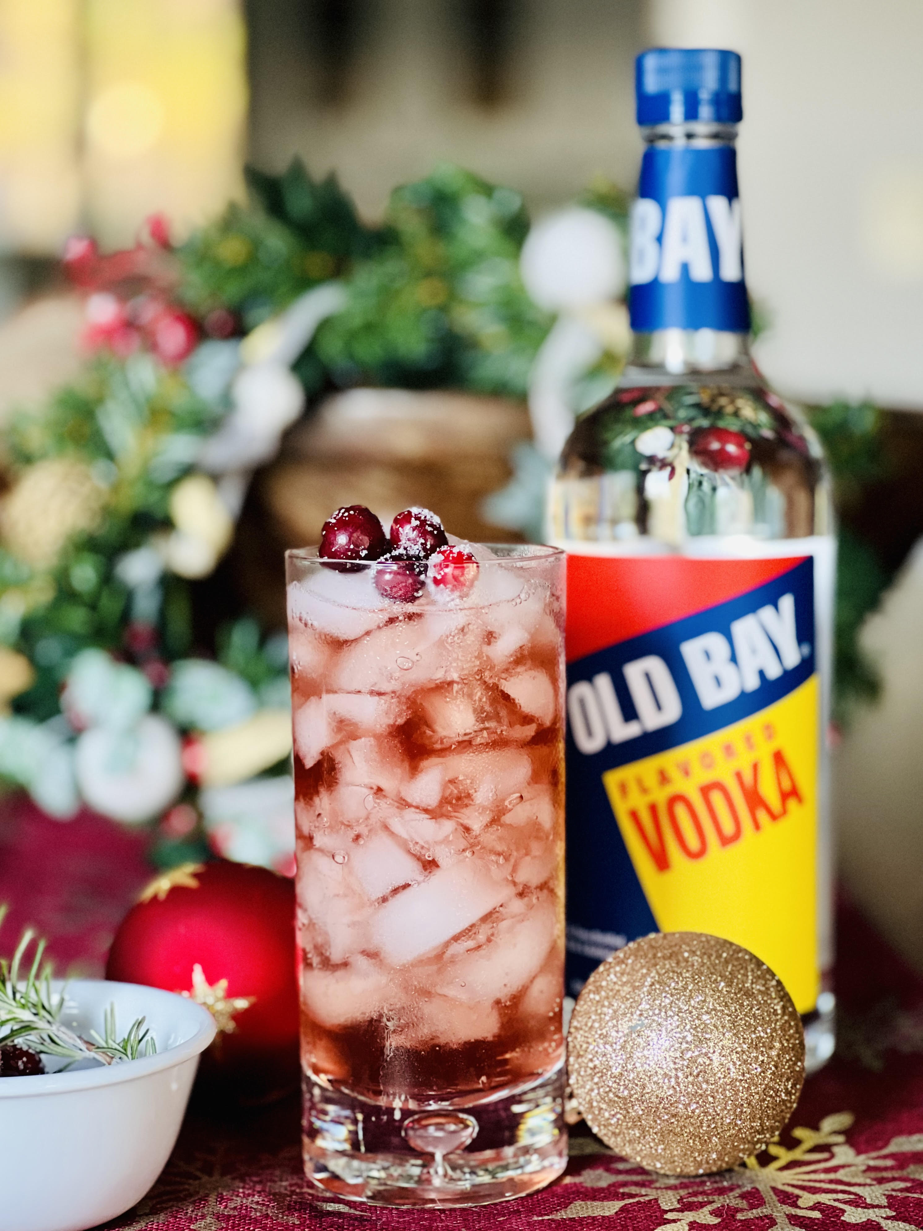 old bay vodka bottle with cranberry cocktail and Christmas decor
